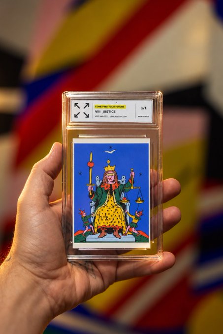 A hand holds a graded PSA card labeled 'VIII JUSTICE' and 'JUSTICE GALLERY' depicting a seated figure with a sword and scales against a colorful abstract background.