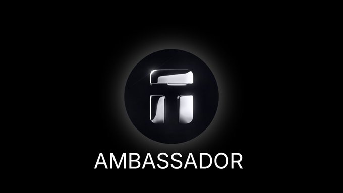 A metallic logo with the letters 'TI' in a circle above the word 'AMBASSADOR' on a black background.