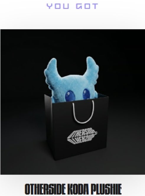 The image features a black bag with a blue stuffed animal inside, which appears to be a toy or plush. The text "You Got It" is written above the stuffed animal, indicating that the viewer has been successful in their attempt to access the item within the bag. The background of the image is dark and out-of-focus, drawing attention to the bag with its contents.