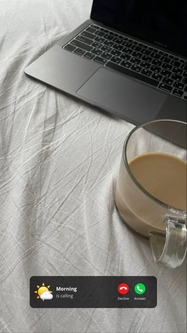 A laptop and a glass of coffee on a white sheet with an incoming call notification reading 'Morning is calling' with Decline and Answer buttons.