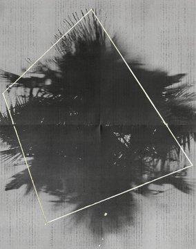 A black inkblot or splattered stain spreads across a textured wooden surface, overlaid with a tilted white square frame that creates a striking contrast against the chaotic dark pattern. The geometric overlay transforms the random ink splatter into a framed abstract composition, echoed in the post's hashtag "#tezostuesday" referencing artistic exploration at toca-me.com.