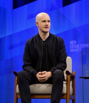 Brian Armstrong, CEO of Coinbase, sits on stage at the New Establishment Summit, likely addressing the company's contingency plans regarding the Clarity Act legislation.