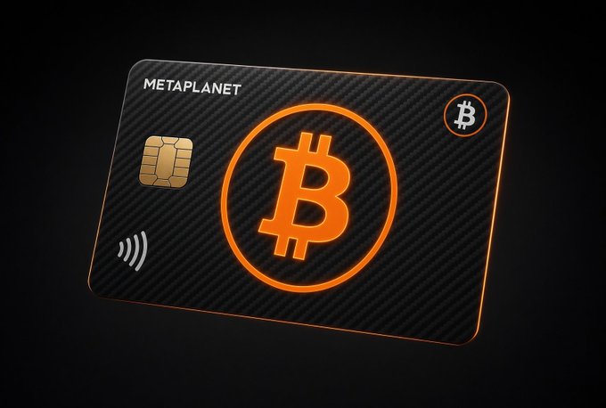 A sleek black Metaplanet-branded credit card featuring a glowing orange Bitcoin logo prominently in the center, along with an EMV chip and contactless payment symbol, floating against a dark background. The card appears to tie into Metaplanet's Bitcoin-focused financial branding, hinting at a crypto-linked payment product tied to the company's BTC holdings.
