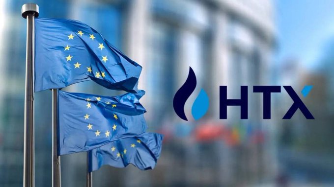 European Union flags flying in front of a building, with the HTX logo (formerly Huobi cryptocurrency exchange) displayed on the right side.