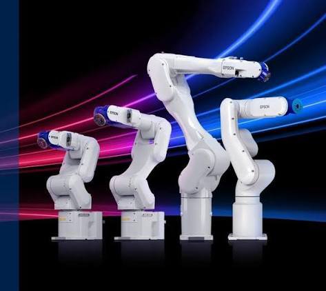 A promotional image showing four white Epson industrial robotic arms of varying sizes arranged in a row against a dynamic blue and pink neon background.