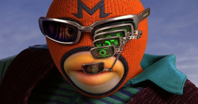 A close-up of a purple penguin character wearing an orange knit mask and multiple silver visors/glasses displaying green digital interfaces, with a blue sky background.
