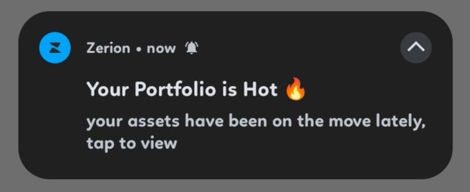 A push notification from Zerion reads 'Your Portofolio is Hot 🔥 your assets have been on the move lately, tap to view.'