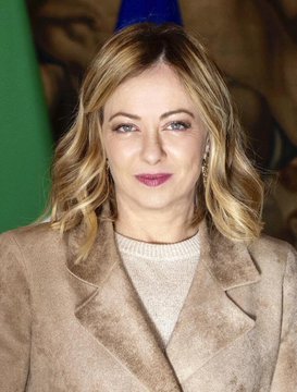 The image features a woman wearing a tan coat, standing against a green background that includes an Italian flag. She appears to be smiling for the camera while posing for the photo. The image also contains text related to Bitcoin & crypto services offered by Banca Sella bank in Italy and Europe's MiCA regulations.