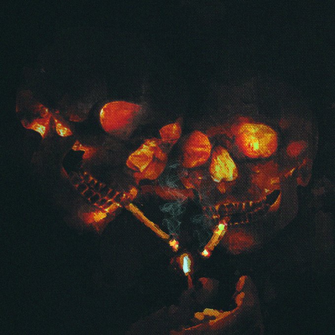 A dark, eerie image shows a sinister face illuminated by the glow of a lit match or lighter held below it, with glowing red eyes and teeth visible in the shadows.