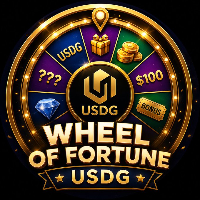 The image features a large circular wheel with various symbols representing different types of games or prizes, including a diamond, a gift box, and a ticket. The wheel also has a "Wheel of Fortune" written above it, indicating that this is a game where players spin the wheel to determine their fortune. The post promotes the game by stating that it's live and encourages people to try it out for free. It mentions that there are five spins every day, which means players can expect to win USDG points with each spin. Additionally, there are three different types of games represented on the wheel: a USDC game, a gift box game, and a ticket game.