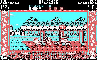 A screenshot of the retro 8-bit video game 'Tiger Road' showing a character fighting enemies with a pole in a level with 'PLAYER', 'ENEMY', 'TIME', and 'HI-SCORE' displayed at the top.