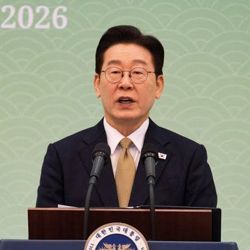 A man in a dark suit and glasses speaks at a podium, with the seal of the South Korean government visible and the year "2026" displayed in the upper left corner of the green backdrop. The image appears to show a South Korean government official announcing the country's new pro-crypto policy, which recognizes virtual assets as a national asset class alongside land and real estate.