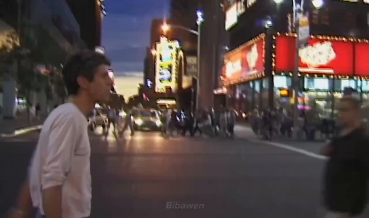 The image shows a man walking down a city street at night, with another person standing nearby. The scene takes place outside of a store or restaurant that has neon signs lit up, creating an urban atmosphere. In the background, there are cars parked along the street and people walking on the sidewalk. A car is also visible in the image.

The post features a link to Michael Saylors' strategy for Bitcoin trading, which includes buying and selling Bitcoins at different times of day based on market trends. The post emphasizes that Bitcoin will begin selling soon, potentially leading to substantial gains for those who invest early enough.