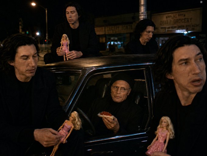 The image features a car with several men sitting inside of it, holding up different objects such as dolls and food like pizza slices. In one photo, there are five people seen in the car, including three older men who appear to be posing for the picture with their toy figures or holding food items. The others seem to be bystanders observing this scene from outside the car. 

In the context of the post, it seems that a mistake was made during the filming process which resulted in this scene being unintentionally directed into the frame. However, there are also some positive elements in the photo: a group of men sitting together and possibly enjoying a meal or sharing a light-hearted moment while inside the car.