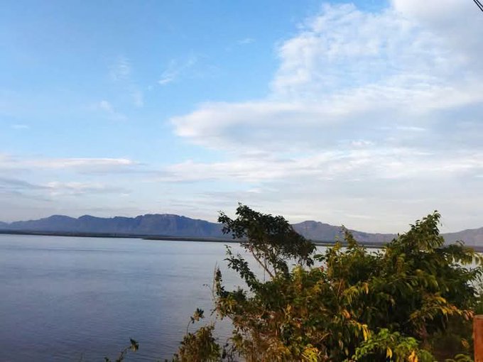 The image shows a beautiful view of a lake surrounded by mountains, with a clear blue sky above. There are trees near the water's edge, adding to the serene atmosphere. The caption reads "Good Afternoon CT A lot of crypto projects talk about community, but very few actually design systems where community participation directly impacts ecosystem growth". This statement is related to the image as it highlights the importance of community involvement in creating sustainable and thriving ecosystems, just like the one depicted in the picture.

The image also features a tree near the water's edge, which adds to the overall natural beauty of the scene. The combination of the lake, mountains, trees, and clear blue sky creates an idyllic setting that showcases the importance of preserving and protecting our environment for future generations.