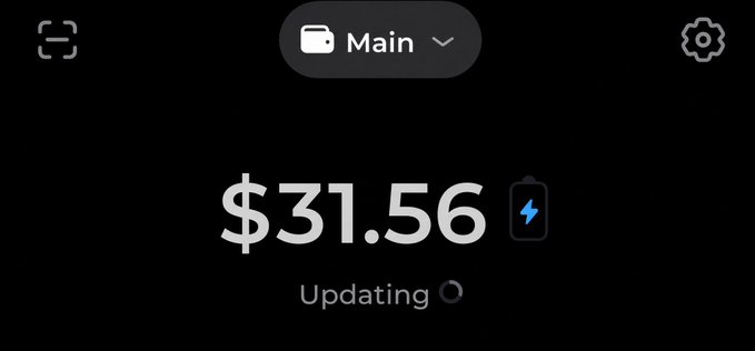 The image shows a banking app display showing a "Main" account balance of $31.56 currently updating. The post jokingly references earning "$30 a day" to afford basic needs, playfully contrasting the modest balance shown in the app.