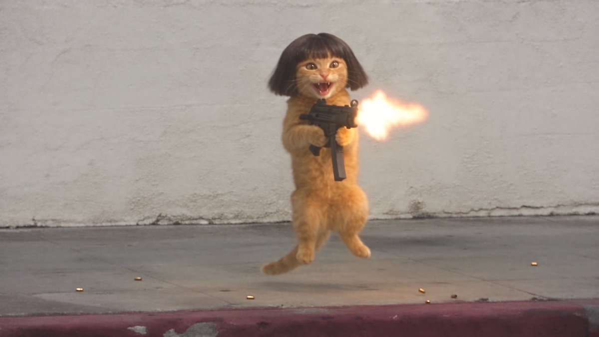 An orange tabby cat wearing a black bob haircut wig stands on its hind legs while firing a submachine gun, with a muzzle flash visible, against a concrete wall.