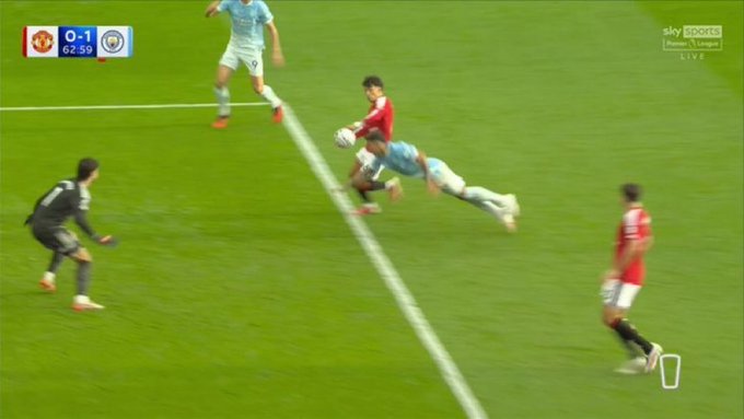 A Sky Sports Premier League broadcast shows the score graphic displaying "0-1" with the match clock at "62:59," capturing a moment of action as a Manchester United player in red contests the ball with a Manchester City player in light blue near the touchline. The image relates to the post by visually depicting the controversial Haaland goal incident, where VAR ultimately ruled him onside despite Enzo Fernández's offside position impacting play.
