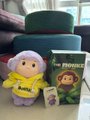 A plush monkey toy labeled "MonkeBuBu" sits beside its packaging box featuring "POPULING" branding, ready to be gifted. The image illustrates the heartwarming unboxing moment mentioned in the post, showing the delivery that brought joy to its recipient.