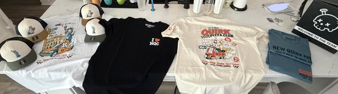 A table displays merchandise including trucker hats, a black 'I ♥ NGOC' t-shirt, a white 'QUIRK NINJA CLUB' t-shirt, and a 'NEW QUIRK CT' sweater.