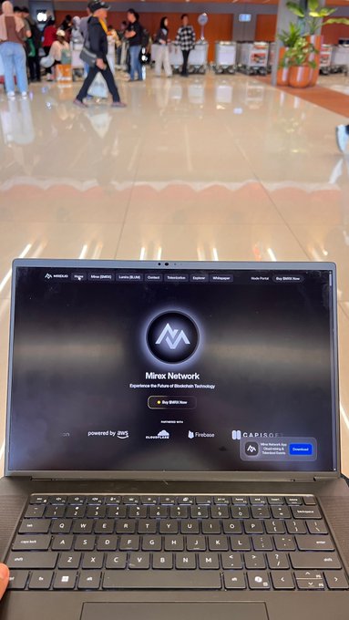 A MacBook displays the **Mirex Network** homepage ("Experience the Future of Blockchain Technology") with "Buy MXRX Now" and partner logos including **AWS** and **Fireblocks**, set against a blurred airport background. The image connects to the post by visually showcasing a blockchain token project (MXRX) as a tangible example of programmable digital ownership beyond mere trading.