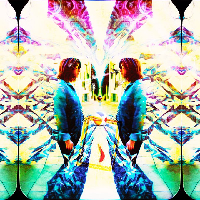 A mirrored, psychedelic digital artwork featuring a person duplicated symmetrically against a vibrant, kaleidoscopic background of pinks, blues, and yellows.