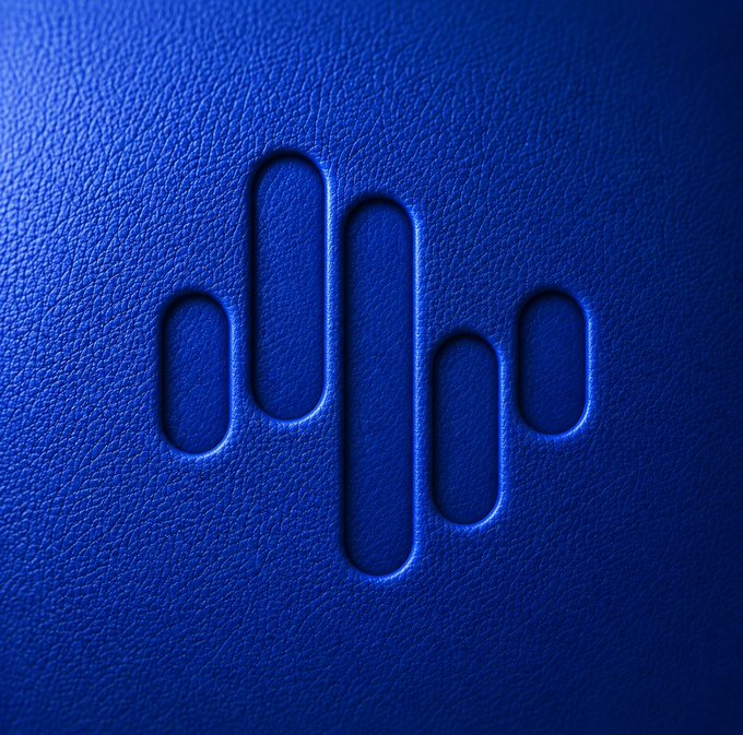 The image features a close-up view of a blue surface with white lines, which appear to be etched into the material. These lines are arranged in a zigzag pattern, creating an interesting visual effect. The background color of the image is blue, providing a contrast that makes the white lines stand out. In the bottom right corner of the image, there's text that reads "$ZIG - @ZIG Chain". This text seems to be related to the design or theme of the image, possibly indicating the brand or logo associated with it.