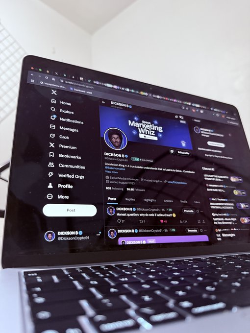 A laptop screen displays the X (Twitter) profile of "DICKSON B (@DicksonCrypto01)" showcasing "Marketing Whiz" branding, illustrating the poster's reunion with their computer after a 3-day absence. The image captures the moment of catching up on crypto-related social media content upon returning to their device.
