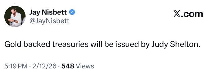 A screenshot of a tweet from verified user Jay Nisbett (@JayNisbett) posted on 2/12/26 at 5:19 PM with 548 views, stating "Gold backed treasuries will be issued by Judy Shelton." The post connects to commentary celebrating Judy Shelton's appointment to the Treasury as a milestone toward mainstream XRP adoption.