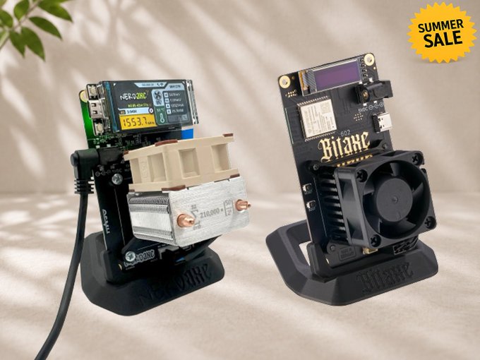 A product photo showcasing two electronic devices on stands, one labeled 'Bitaxe' and another appearing to be a 'NerdQ++' miner, with a yellow 'SUMMER SALE' badge in the corner.