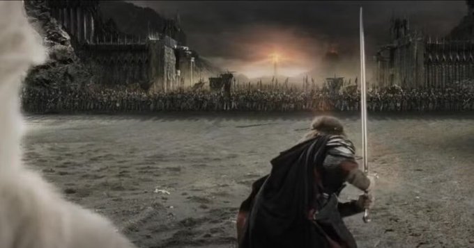 A scene from a fantasy film shows an armored warrior with a sword facing a massive army in front of dark castle walls, reminiscent of the Battle of Pelennor Fields in Lord of the Rings.