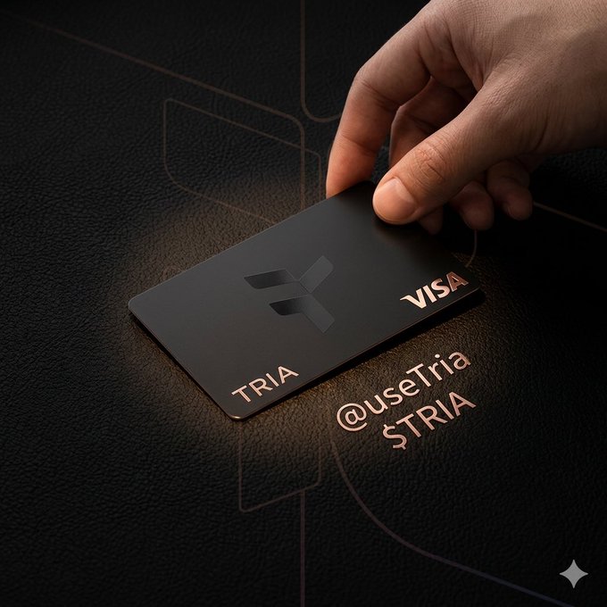 The image shows a person's hand holding a black Visa card with the word "Visa" written on it, which is placed on top of a dark surface such as a table or a piece of leather. The background of the image features a purple line that appears to be a logo for a cryptocurrency called "Tria". The caption below the image reads: "I used to think crypto adoption was about education Teach people about wallets Teach people about gas Teach people about bridges Now I think the opposite is true @useTria gets this No seed phrases No gas".