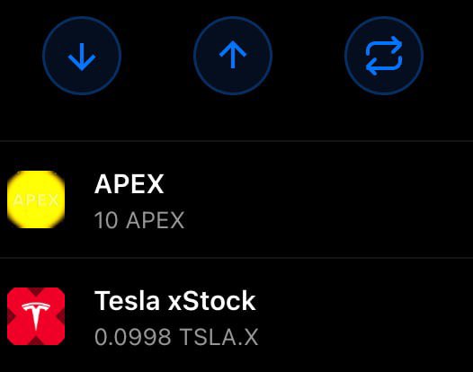 The screenshot shows a crypto wallet interface displaying two assets: "APEX" with a balance of 10 APEX, and "Tesla xStock" (TSLA.X) with a balance of 0.0998 TSLA.X, alongside sort and refresh buttons. This visualizes the post's announcement of TSLA.x becoming the first tradable stock available on the X1 blockchain, redeemable for TSLAx on Solana.