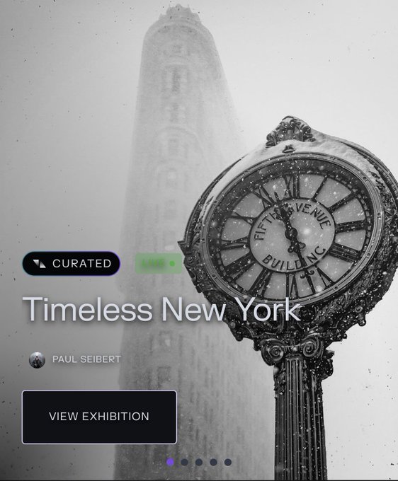 A black-and-white photo of a snow-covered Fifth Avenue Building Co. clock with the Flatiron Building rising in the misty background, overlaid with a digital gallery interface promoting "Timeless New York" by Paul Seibert as a curated NFT exhibition on Transient Labs. The atmospheric vintage scene complements the post's nostalgic invitation to relive NYC moments through collectible imagery.