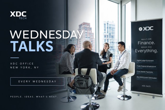 This promotional graphic advertises "Wednesday Talks" hosted by XDC Tech at the XDC Office in New York, NY, every Wednesday, featuring the tagline "People. Ideas. What's Next." The image shows a group of professionals engaged in discussion seated around a small table in a modern office setting with large windows revealing a cityscape, alongside an XDC branded banner reading "Built for Finance. Ready for Everything." and listing topics like Digital Ledger Ecosystem, Trade Finance Infrastructure, Cross-Border Payments, and Real-World Asset Tokenization (xdc.tech). The accompanying post indicates these Wednesday sessions this fall unite founders, operators, investors, and institutions to discuss the future of finance and technology, kicking off with partners Plug and Play TC and IBM, reinforcing the image's professional networking theme.