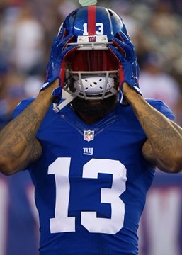 A close-up shot of New York Giants wide receiver Odell Beckham Jr. (jersey #13) adjusting his blue helmet, following a game in which he failed to score a touchdown.