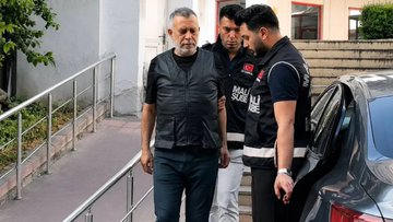 Two uniformed officers escort a handcuffed older man with a gray beard down a set of stairs toward a police vehicle, consistent with the post about an investigation into Haluk Levent's alleged cryptocurrency transactions via Binance TR totaling around 88 million TL across 387 transactions.