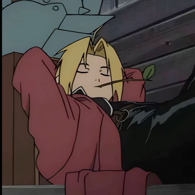 An anime screenshot depicts a blonde character (resembling Edward Elric from Fullmetal Alchemist) sleeping peacefully in a red outfit with a small leaf in their mouth, with a suit of armor in the background.