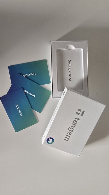 A Tangem hardware wallet package with a white box labeled 'tangem' and 'Getting started', accompanied by three blue-green 'SOLANA' branded crypto cards.