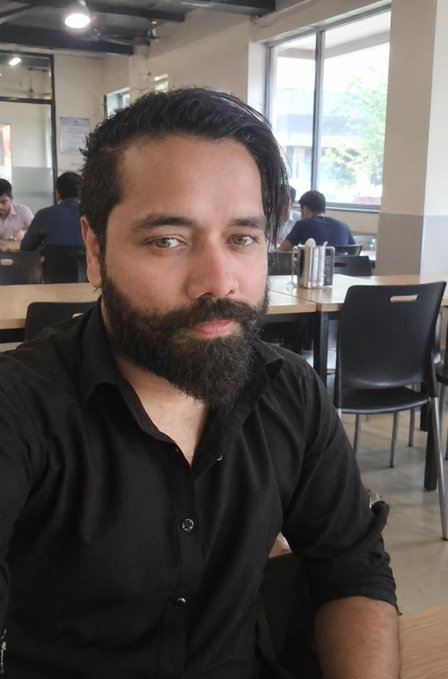 A bearded man in a black shirt takes a selfie in what appears to be a casual cafeteria or co-working space, with other people visible working in the background. The image accompanies a "Good Night X Mates" message celebrating reaching a 13K community milestone in Web3.