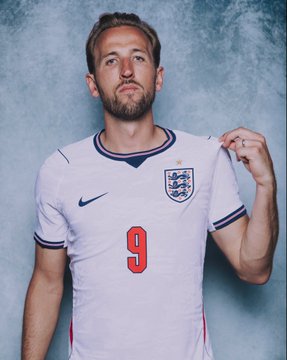 Portrait of footballer Harry Kane wearing the England national team away kit with the number 9 and Three Lions crest.