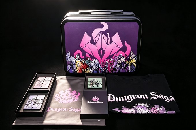 A promotional display for 'Dungeon Saga' featuring a black carrying case with character artwork, alongside t-shirts, trading cards, and packaging materials branded with the game's logo.