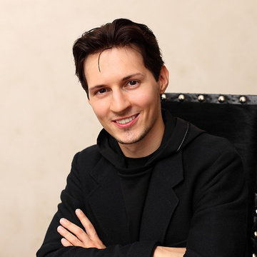 The image shows a smiling man with dark hair wearing a black jacket, arms crossed, seated in a studded black chair. He appears to be Pavel Durov, the Telegram founder referenced in the post announcing the upcoming launch of the non-custodial GRAM wallet for the platform's over one billion users.