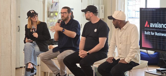 Four individuals seated on white stools participating in a panel discussion, with a screen displaying the 'Avalanche' logo and 'Built for Business' text visible on the right.