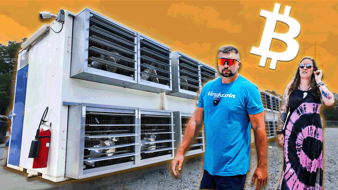 A man in a blue 'Verkcoin' shirt and a woman in a tie-dye outfit stand in front of a large industrial Bitcoin mining container, with a Bitcoin logo overlaid on an orange sky.