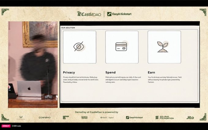 A presentation slide from CastleDAO at a Demo Day, featuring 'OUR SOLUTION' with three pillars: Privacy, Spend, and Earn, alongside a blurred image of a presenter and various sponsor logos.
