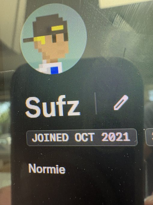 The image shows a profile from OpenSea displaying the username "Sufz," who joined in October 2021 and is labeled as a "Normie," with a pixelated avatar wearing sunglasses in the background. This visual confirms the post's claim that OpenSea has officially designated them as a "normie."