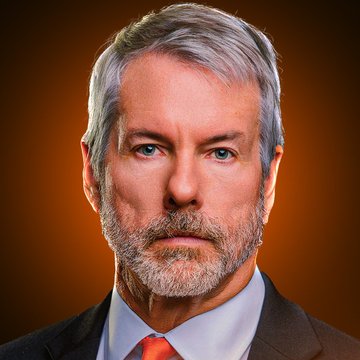 A headshot of a gray-haired man in a dark suit and red tie, likely Michael Saylor, shown against a warm orange background in connection with his statement that Bitcoin advocacy is protected free speech and does not require government licensing.