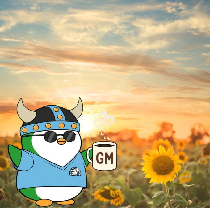 A cartoon penguin wearing a Viking helmet and sunglasses holds a steaming mug labeled 'GM' against a backdrop of a sunflower field at sunset.