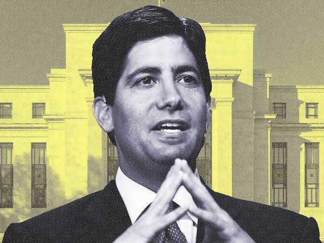 An illustration of a man in a suit with his hands clasped, set against a yellow-tinted image of the White House.